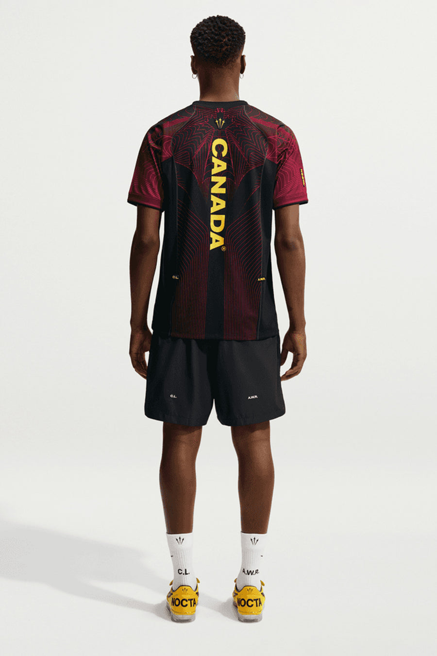 Nike NOCTA x Canada Short Sleeve Top in Black/University Red/Sonic Yellow - Notre